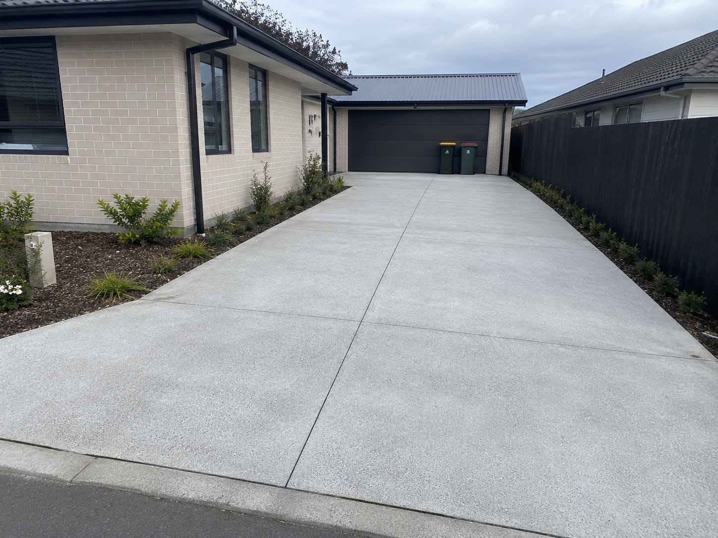 Modern concrete driveway installation in Tauranga